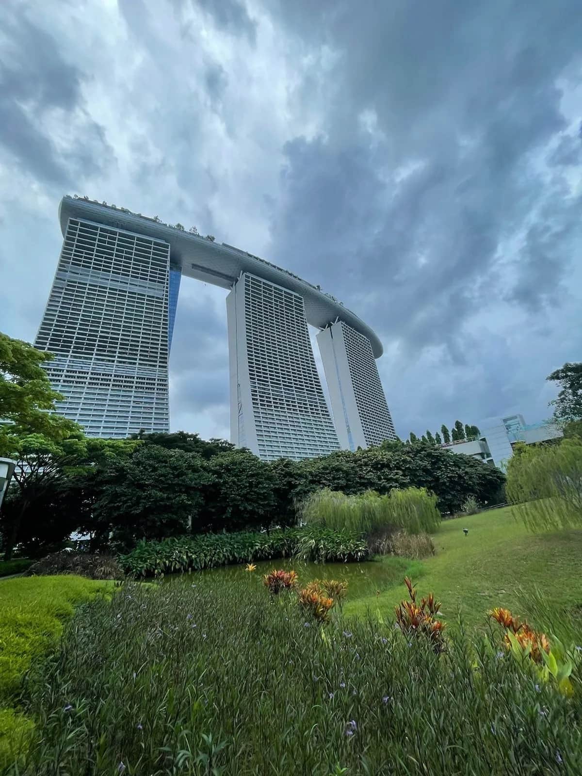 Marina Bay Sands rising over the gardens under heavy storm cloud, Singapore 2023