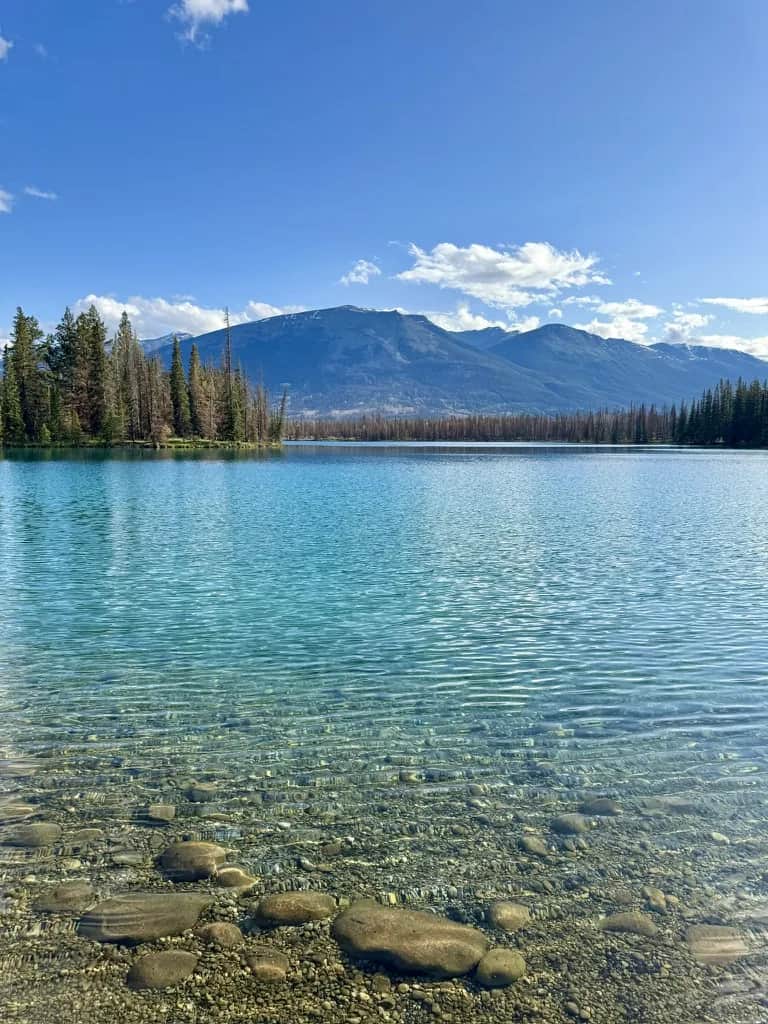 Clear shallows over pale stones with the range across the water, Jasper
