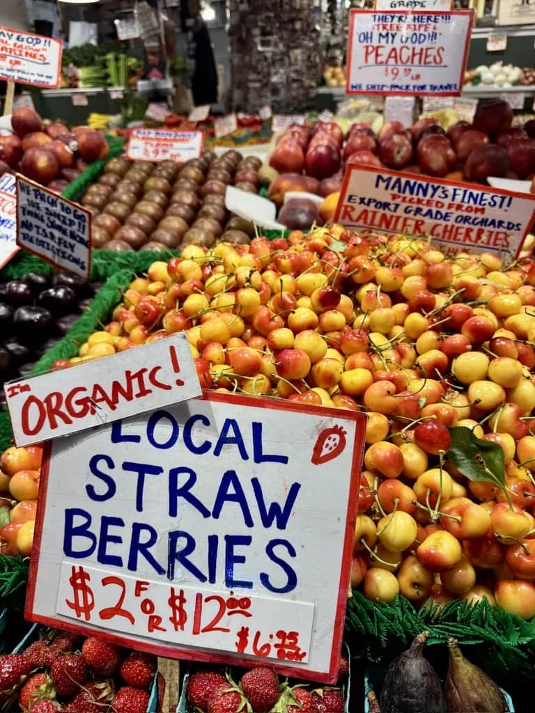 Rainier cherries and hand lettered signs at a market stall, Pike Place Market Seattle