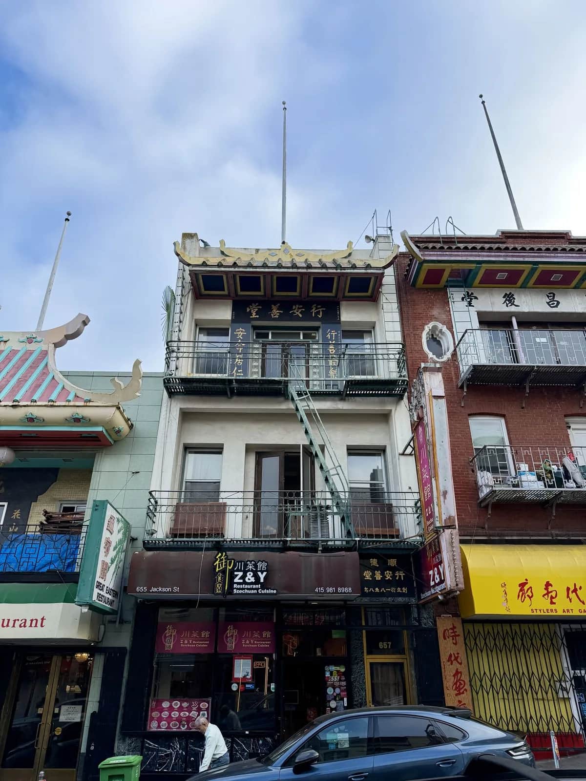 Painted balconies and stacked restaurant signs on Jackson Street, Chinatown San Francisco