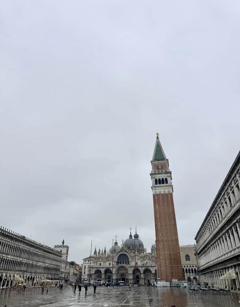 The campanile and the basilica across a rain soaked Piazza San Marco, Venice